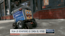 a robot with a mustache is driving down the street in front of a building