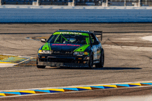 a green and black race car with the word tirerack on the side