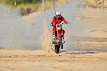 a man riding a dirt bike with the number 92 on it