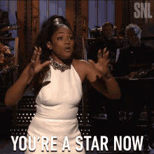 a woman says you 're a star now in front of a snl sign