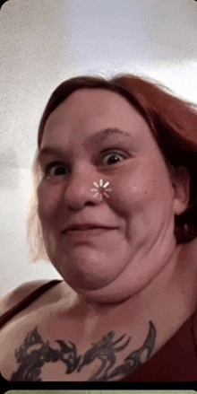 a woman with a tattoo on her chest makes a face