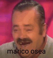 a man with a mustache is laughing with the words marico osea written next to him .