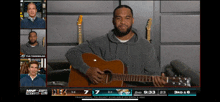 a man playing an acoustic guitar on espn