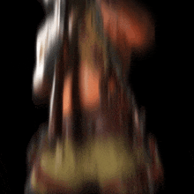 a blurred image of a person 's back with a dark background