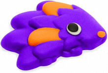 a purple and orange rubber toy with a black eye