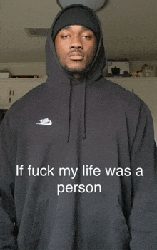 a man wearing a black nike hoodie with the words if fuck my life was a person on the front