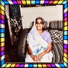 a woman is sitting on a couch with a stained glass frame around her