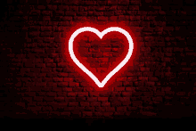 a neon sign in the shape of a heart on a brick wall .