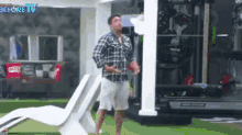 a man in a plaid shirt is standing in front of a treadmill in a gym with the words before tv on the bottom