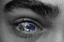 a close up of a person 's eye with a globe in it