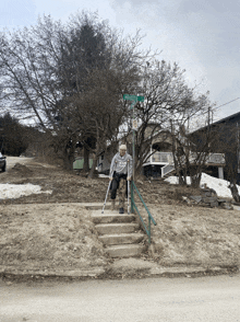 a man with crutches is walking up a set of stairs in front of a street sign that says brooks