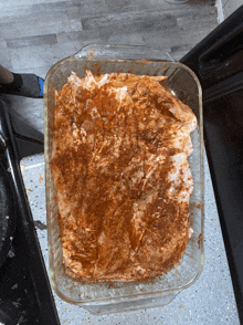 a casserole dish filled with chicken covered in cinnamon and spices