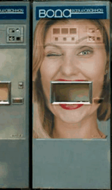 a vending machine with a woman 's face on it and the word vodo on it