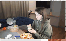 a woman sitting at a desk with a bowl of food in front of her and the words medium wall visible