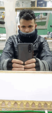 a man is taking a picture of himself in a mirror with a phone that says shot on vivo 51