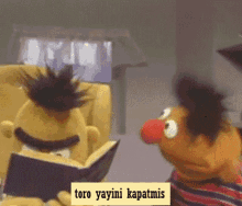 sesame street characters reading a book with a caption that says toro yayini kapatmis