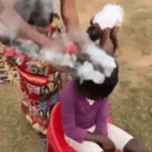 a woman is washing a child 's hair with soap .