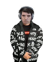 a man wearing headphones and a black jacket that says supreme