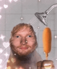 a man is taking a shower and holding a popsicle in front of his head