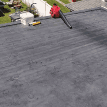 a red leaf blower is sitting on top of a roof .