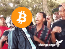 a group of people are dancing in front of a bitcoin sign