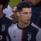 a close up of a soccer player wearing a juventus jersey standing in a crowd .