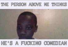 a picture of a boy with the words `` the person above me thinks he 's a fucking comedian '' written on it .