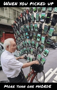 an older man riding a bike with a bunch of phones hanging from a pole with the number 14 on them