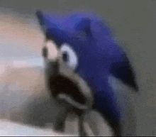 a close up of a stuffed animal of sonic the hedgehog with his mouth open .