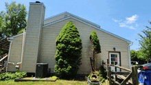 the back of a house with a chimney on the side