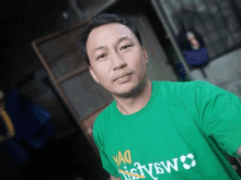 a man wearing a green t-shirt with yao written on it