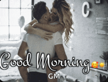 a picture of a man and woman kissing with the words good morning gm on the bottom