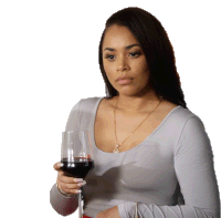 a woman holding a glass of red wine with a necklace that says ' sd ' on it