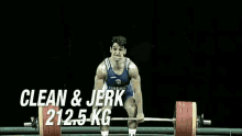 a man lifts a barbell in front of a crowd with a shield that says ' a ' on it