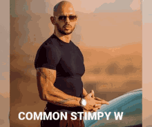 a bald man wearing sunglasses and a black shirt is standing next to a car with the words " common stimply w " on the bottom