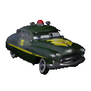 a green police car with a yellow eagle on the hood is sitting on a white surface .