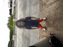 a man with long curly hair wearing a blue polo shirt