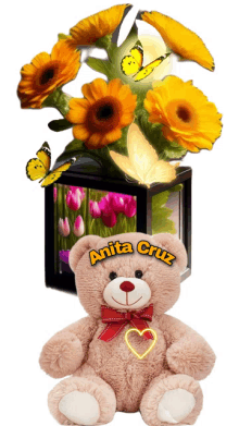 a teddy bear with anita cruz written on it sits next to a vase of flowers