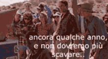 a group of people standing next to each other with the words " ancora qualche anno e non dovremo più scavare "