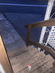 a wooden staircase with a red sticker on the bottom that says ' a '