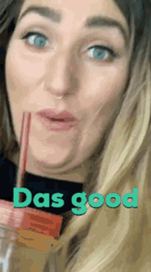 a woman is drinking through a straw with the words das good written below her