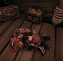 a video game character is laying on the floor next to a chest that says ca on it