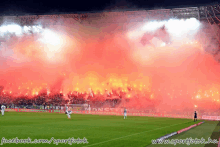 a facebook.com/sportfotok photo of a soccer field with flames