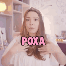 a woman with the word poxa written in pink on her chest