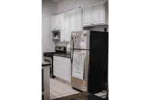 a kitchen with a black refrigerator and a white towel that says new york on it