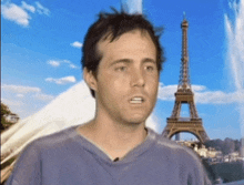 a man stands in front of the eiffel tower in paris