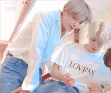 a man wearing a white shirt that says love 's on it