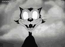 a black and white cartoon cat with glowing eyes is smiling and looking at the camera .