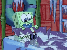 a cartoon character named spongebob is sitting on a table holding a piece of ice