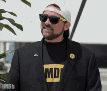 a man wearing sunglasses and a t-shirt that says imdb on it